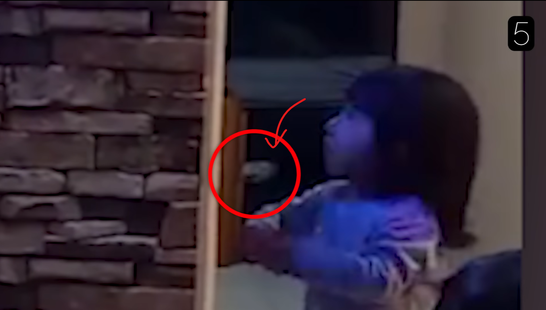 Is this a hand of a ghost? While the girl is watching TV, the door from an adjacent room closes on its own.