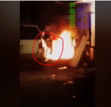From an unknown video source, a shadowy figure is captured walking across a fire.