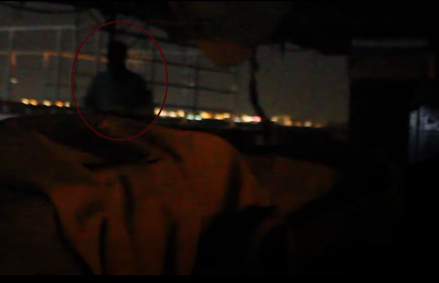 A transparent apparition of a shadowy figure is caught on camera while the investigators are walking around the building.