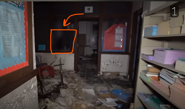 A shadowy figure is caught while the explorer is looking through the abandon building.