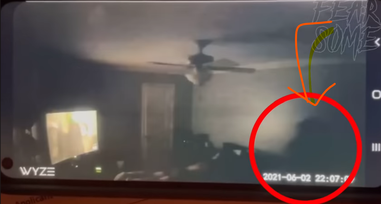 User is reviewing security video footage, when all of a sudden a shadowy figure is caught on camera.