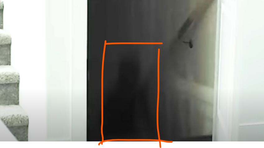Shadowy figure is seen walking up the stairs from the basement area.