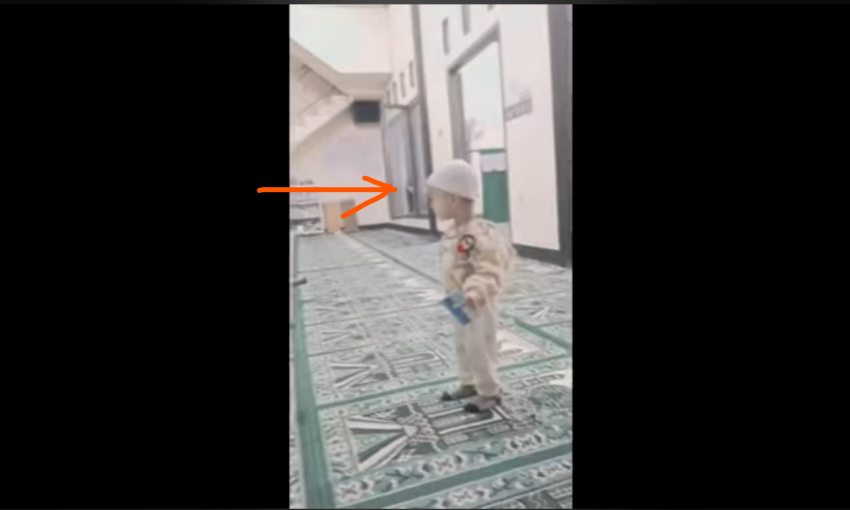 An apparition of a little girl is seen peeking out a window playing with the baby and boy, but the person holding the video record does not see it nor notice it.