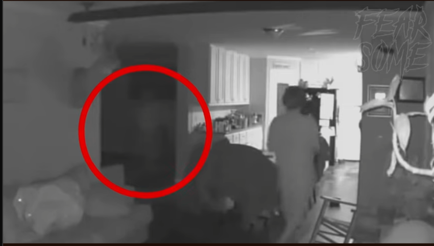 An apparition is caught on camera walking across, and it's not noticed by the kid.